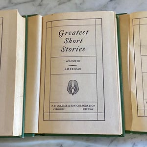 May include: Three hardback books titled "Greatest Short Stories" with volumes I, II, and VI. Volume I and II are labeled "American" and Volume VI is labeled "Foreign".
