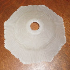 May include: White frosted glass lampshade with a scalloped edge and a central hole for a light bulb.