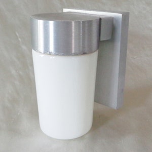 May include: A white frosted glass outdoor light fixture with a silver metal base and a square mounting plate.