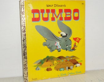 May include: A vintage Little Golden Book featuring Walt Disney's Dumbo. The cover shows Dumbo flying with his ears outstretched, a circus tent in the background, and the text "Walt Disney's DUMBO a Little Golden Book".