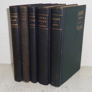 May include: A set of seven vintage hardcover books with green and black covers. The titles include "Treasure Island", "Julius Caesar", "Lorna Doone", and "Ivanhoe".