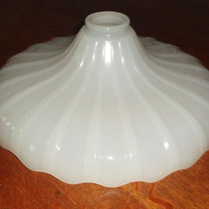 May include: White frosted glass lampshade with a fluted design. The shade is shaped like a bell with a rounded top.