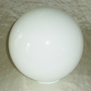 May include: A white, opaque, round glass globe. The globe is smooth and has a slight sheen.