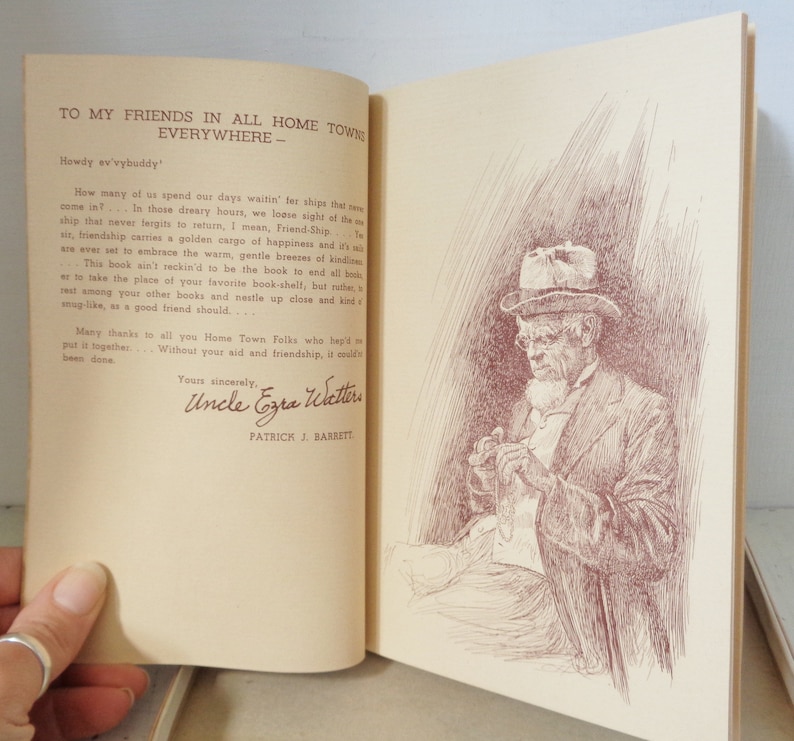 May include: A vintage book with a brown cover and a handwritten dedication to friends in all hometowns. The text reads "To my friends in all hometowns everywhere - Howdy ev'vybuddy". The book is open to a page with a black and white illustration of a man in a hat and coat, sitting and holding a small object in his hands.