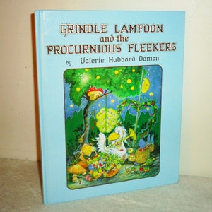 May include: A children's book titled "Grindle Lamfoon and the Procurious Fleekers" by Valerie Hubbard Damon. The cover is light blue with a colorful illustration of whimsical creatures and a tree with a mushroom house.