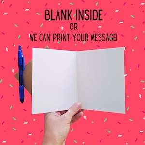 May include: A blank white card with a brown envelope and a blue pen. The card has the text "BLANK INSIDE OR WE CAN PRINT YOUR MESSAGE!" printed on the front.