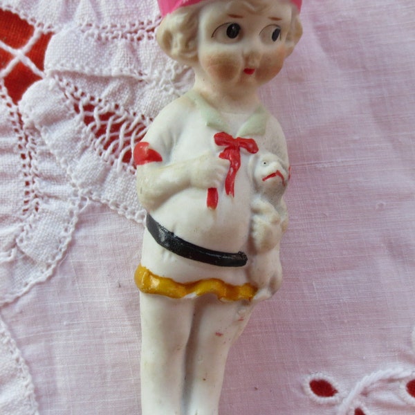 Vintage bisque Frozen Charlotte doll with puppy