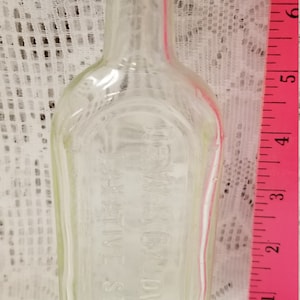 Vintage Dr. W.B. Caldwell&#39;s clear bottle with cork stopper.