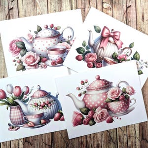 May include: Four square art prints featuring watercolor illustrations of teacups, teapots, roses, and berries. The teapots have pink polka dots and bows. The teacups and teapots are surrounded by pink roses and green leaves. The background is a wooden surface.