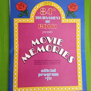 May include: A vintage souvenir program from the 84th Tournament of Roses in 1973. The cover is blue, pink, and yellow, with the words "Movie Memories" in large white letters. Features two red rose illustrations.