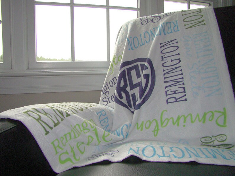 May include: White personalized blanket with the names Remington, Steele, and the monogram RGS in purple on a white background.