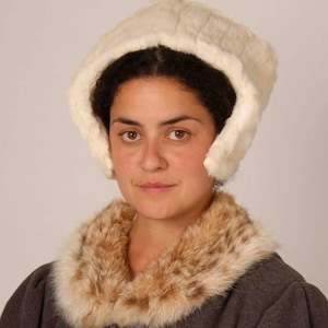 May include: A white fur hat with ear flaps and a brown fur collar.