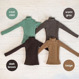 May include: Four long-sleeved turtlenecks in different colors: cool mint, warm gray, dark brown, and beige.