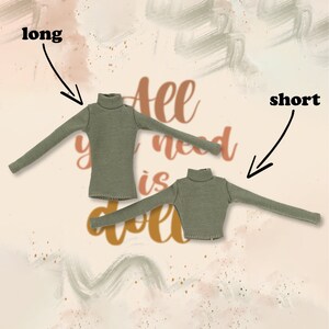 May include: Two green turtleneck shirts, one long sleeve and one short sleeve. The text "All you need is doll" is visible in the background.