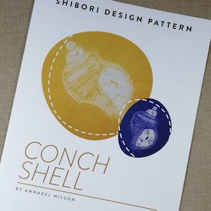 May include: A white paper featuring the text "SHIBORI DESIGN PATTERN" and "CONCH SHELL" with a yellow and blue conch shell design. The design is by Annabel Wilson.