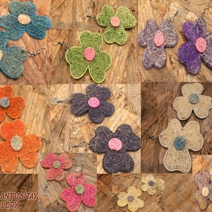 May include: A collage of 10 pairs of flower-shaped earrings made from natural fibers. Each pair features a different color combination, including blue, green, purple, orange, pink, and beige. The earrings are handmade and have a rustic, bohemian aesthetic.