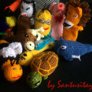 May include: A collection of colorful knitted finger puppets, including a bee, a turtle, a whale, a lion, a pig, a banana, a cat, and a pair of glasses. The puppets are all handmade and have unique details.