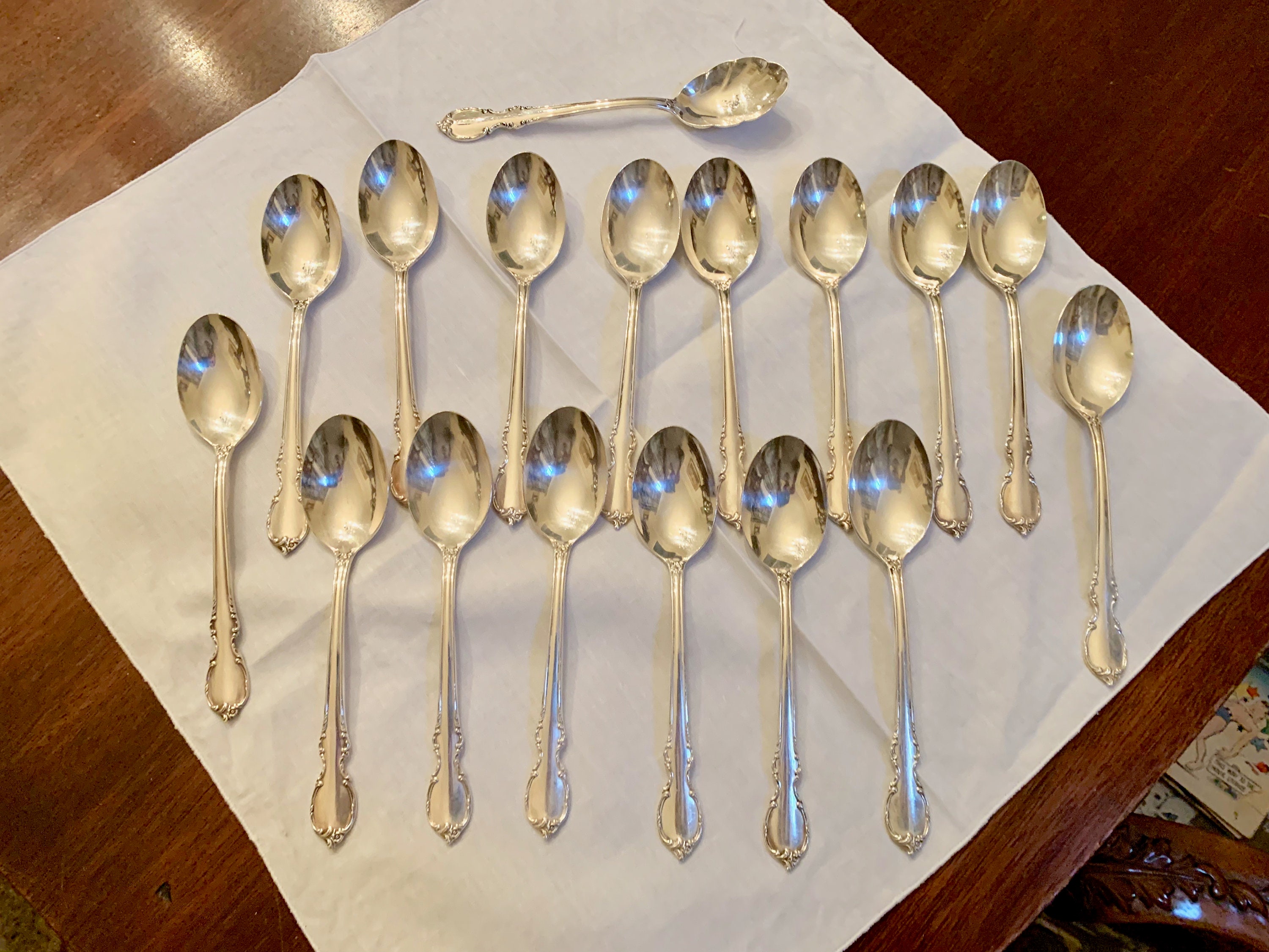 Ornate Silver Teaspoons, Four Spoons with Floral Handles, Arranged in a  Fan-like Manner and Connected