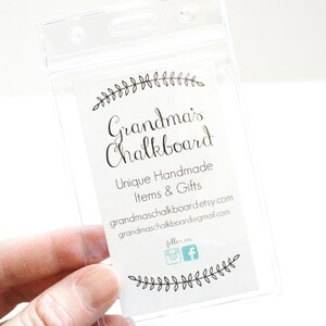 May include: A clear plastic badge holder with a white card inside. The card has black text that reads "Grandma's Chalkboard", "Unique Handmade Items & Gifts", "grandmaschalkboard.etsy.com", "grandmaschalkboard@gmail.com", and "follow on" with Instagram and Facebook icons. The card is decorated with a black floral design.