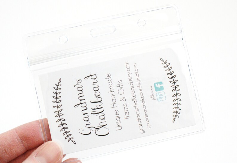 May include: A clear plastic badge holder with a white card inside. The card has black text that reads "Grandma's Chalkboard" and "Unique Handmade Items & Gifts". The card also has a website address, "grandmaschalkboard.etsy.com", and an email address, "grandmaschalkboard@gmail.com".