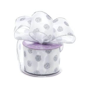May include: A roll of white satin ribbon with silver glitter polka dots. The ribbon is 2.5 inches wide and is perfect for adding a touch of sparkle to your crafts and gifts.