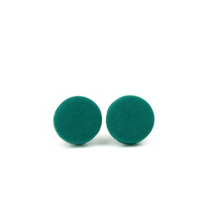 May include: A pair of teal green round stud earrings.