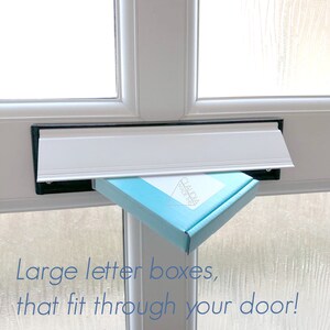 May include: A light blue box with the text "CLAUDIA MADE THIS" in white lettering is being delivered through a white mailbox.