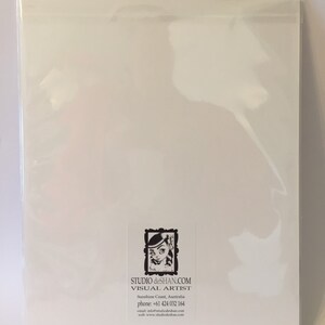 May include: A white card with a black and white illustration of a girl with a flower in her hair. The card has text that reads "STUDIO deSHAN.COM VISUAL ARTIST Sunshine Coast, Australia phone: +61 424 032 164 email: info@studiodeshan.com www: www.studiodeshan.com"