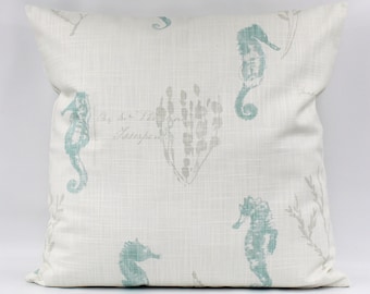 May include: A white throw pillow with a light blue and gray seahorse and seaweed pattern. The pillow has a subtle linen texture and features the text "For the People, Always".