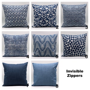 May include: Eight blue and white patterned throw pillow covers with invisible zippers. The patterns include geometric, chevron, and polka dot designs.