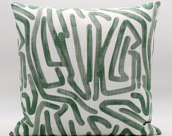 May include: A green and white cushion with an abstract pattern of lines and curves.