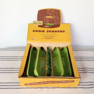 May include: Vintage "Sow-Rite" corn servers set in original box. The box is yellow with brown accents and features a graphic of a person serving corn. Includes four green corn-on-the-cob dishes and corn holders.