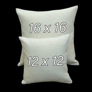 two white square pillows with the numbers "16 x 16" printed on them.