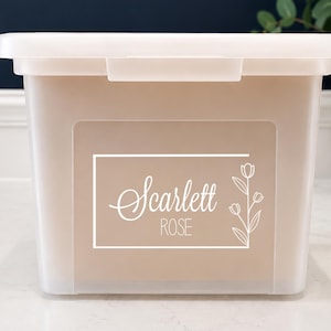 May include: A translucent plastic storage bin with a lid, featuring a white rectangular decal on the front. The decal displays the name Scarlett Rose in a combination of script and sans-serif fonts, accompanied by a simple line drawing of a flower.