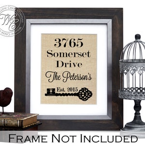 May include: A framed print on burlap fabric with the text "3765 Somerset Drive The Peterson's Est. 2015" and a black silhouette of a key.