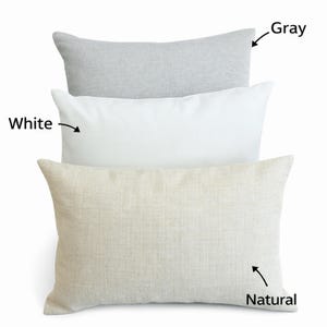 three different colored pillows, each labeled with its color: white, gray, and natural.