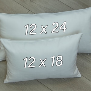 May include: Two white pillowcases with black text. The larger pillowcase reads "12 x 24" and the smaller pillowcase reads "12 x 18".