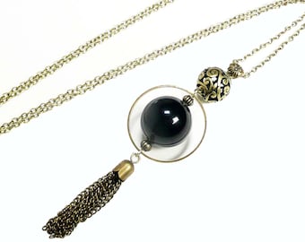 Long pendant necklace, bronze jewelry, long pompom pendant, black beaded encircled necklace,vintage jewel