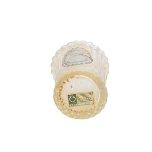 Pu&ograve; includere: Un flacone di profumo vintage in vetro trasparente con bordo e base smerlati. La bottiglia ha un corpo cilindrico e una base rotonda. Due etichette sono apposte sulla bottiglia. La bottiglia &egrave; posta su uno sfondo bianco.