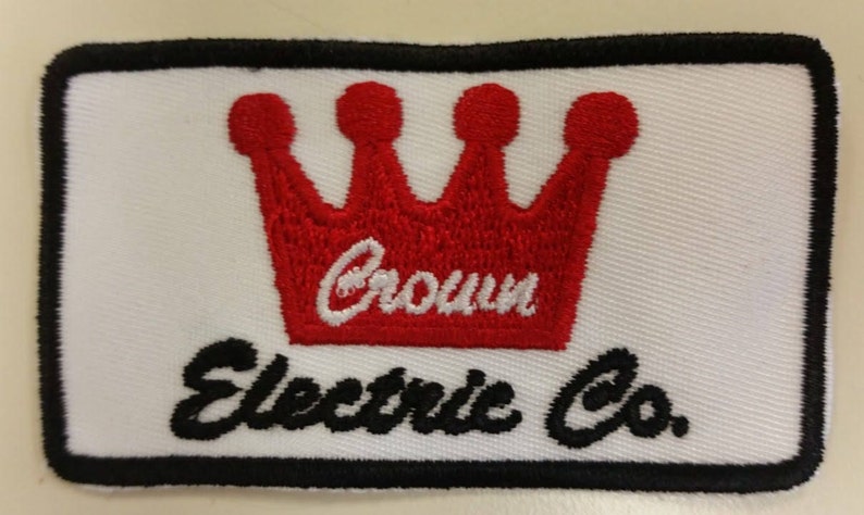 May include: White embroidered patch with a red crown and the text "Crown Electric Co."