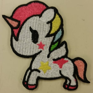 May include: A white unicorn with a pink, yellow, blue, and green mane and tail. The unicorn has a black outline and a black eye. The unicorn has a pink star on its cheek and a yellow star on its side.