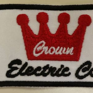 May include: A white embroidered patch with a red crown and the text "Crown Electric Co."