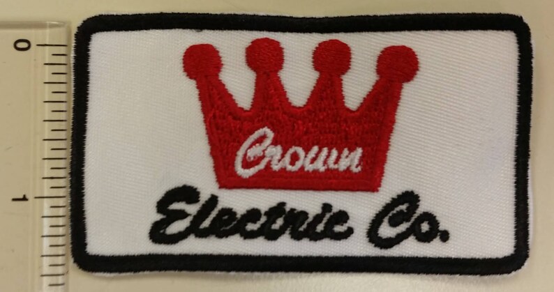 May include: A white embroidered patch with a red crown and the text "Crown Electric Co."