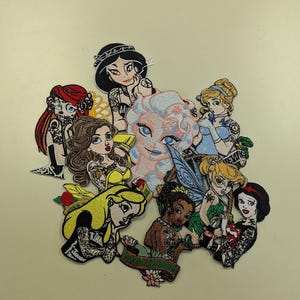 May include: A collection of embroidered patches featuring stylized illustrations of various princesses. Each patch showcases a unique design with vibrant colors and intricate details, perfect for adding to clothing or accessories.
