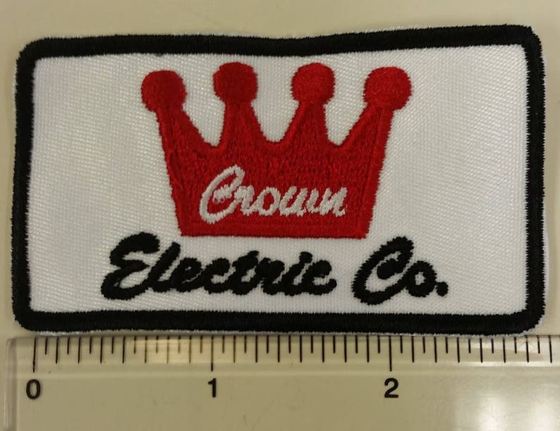 May include: A white embroidered patch with a red crown and the text "Crown Electric Co."