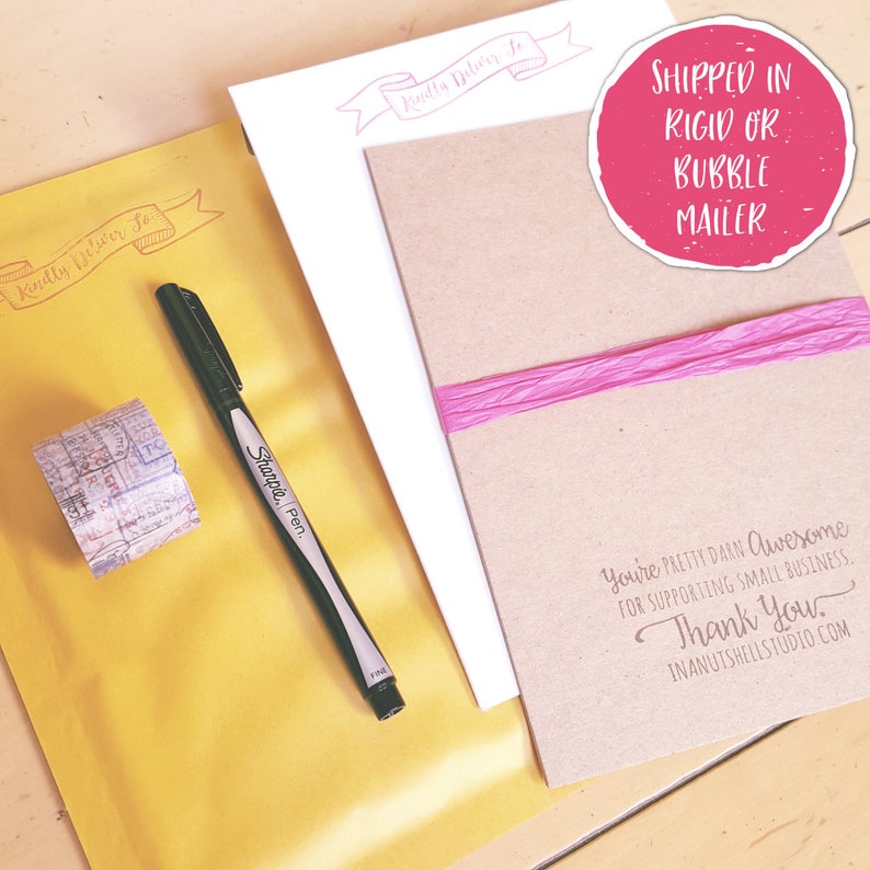 May include: A yellow mailing envelope with a red stamp that says "Kindly Deliver To". A black Sharpie pen and a roll of patterned washi tape are on the envelope. A brown card with the text "You're pretty darn awesome for supporting small business. Thank you. Inanutshellstudio.com" is on top of the envelope. A pink ribbon is on the card. A pink circle with the text "Shipped in rigid or bubble mailer" is in the top right corner of the image.