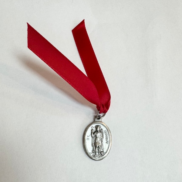 St Expedit silver oxide medal worn for protection 1” with red ribbon