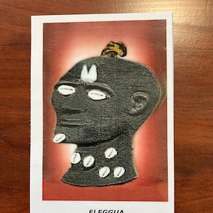 ELEGGUA 4x6 Prayer card in English ELEGGUA 4x6 Tarjeta de Oración Laminada en ingles