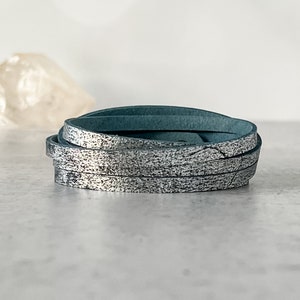May include: A roll of teal leather cord with a silver metallic finish.