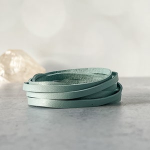 May include: A roll of light blue leather cord, perfect for crafting jewelry or other projects.